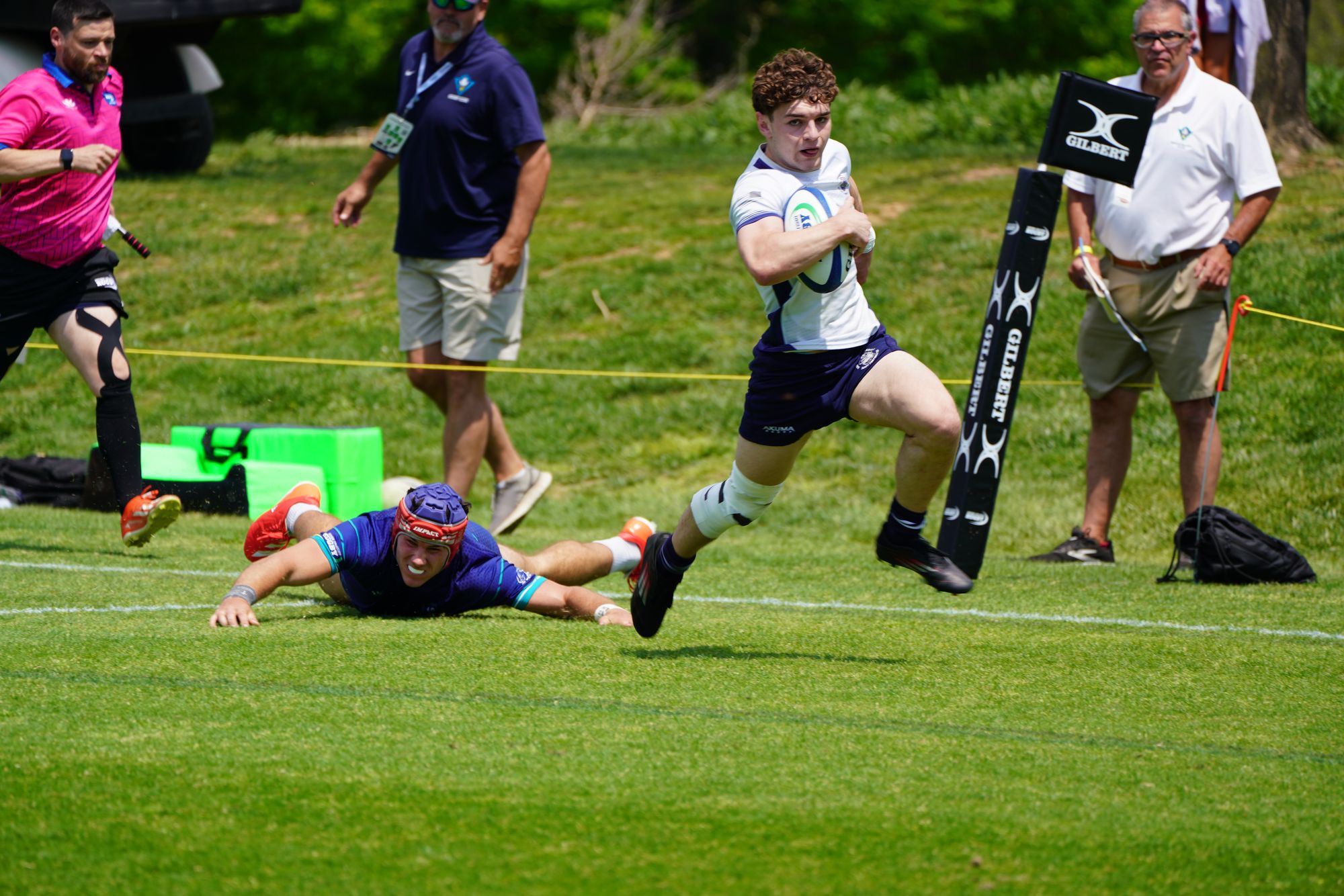 A GURFC player breaking a tackle to score in the corner