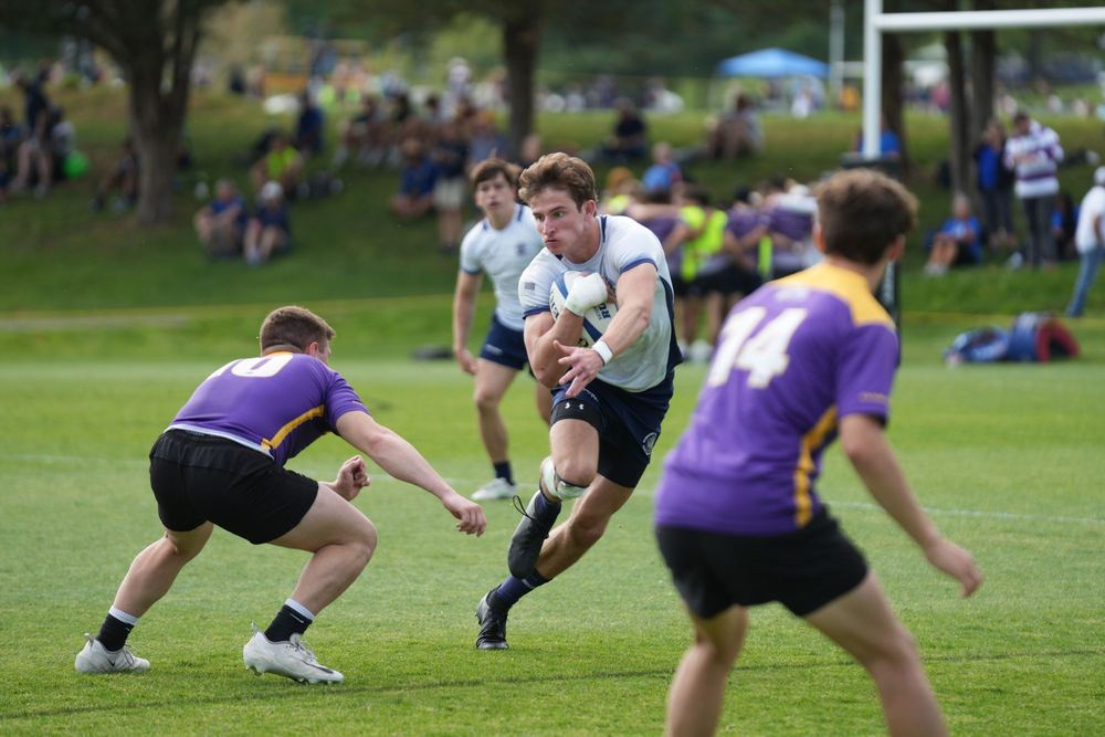 A GURFC player stepping inside two defenders